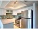 Bright kitchen boasts granite countertops, stainless steel appliances, and white cabinetry at 4410 Warren Ave # 104, Port Charlotte, FL 33953