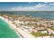 Expansive aerial view of coastal community featuring beachfront properties, clear waters, and a picturesque landscape at 5030 N Beach Rd # 1, Englewood, FL 34223