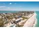 Stunning aerial view of beachfront property with turquoise water and clear blue skies, perfect for coastal living at 5030 N Beach Rd # 1, Englewood, FL 34223