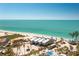 Elevated aerial view of beachfront homes, palm trees, and turquoise ocean at 5030 N Beach Rd # 1, Englewood, FL 34223