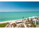 High-angle shot of a coastal neighborhood, sandy beach, and clear ocean waters at 5030 N Beach Rd # 1, Englewood, FL 34223
