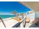 Balcony view of the beach with lounge chairs at 5030 N Beach Rd # 1, Englewood, FL 34223
