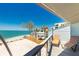 Balcony view of the beach with lounge chairs at 5030 N Beach Rd # 1, Englewood, FL 34223