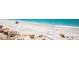 Beautiful beachfront with rocks, sand, and blue water at 5030 N Beach Rd # 1, Englewood, FL 34223