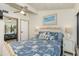 Comfortable bedroom boasts ceiling fan, closet, and beach-themed decor at 5030 N Beach Rd # 1, Englewood, FL 34223