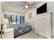 Bright bedroom features vaulted ceiling, ceiling fan, and large window for natural light at 5030 N Beach Rd # 1, Englewood, FL 34223