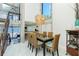 Dining room overlooking the ocean view, featuring a modern chandelier and seating for six at 5030 N Beach Rd # 1, Englewood, FL 34223