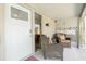 Home's front entrance with sitting chairs, decorative wall art, and outdoor lighting at 5030 N Beach Rd # 1, Englewood, FL 34223