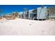 Elevated beach houses offer ample parking and storage under a bright blue sky at 5030 N Beach Rd # 1, Englewood, FL 34223