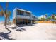 Elevated beach houses showcase covered parking and storage with views of nearby properties at 5030 N Beach Rd # 1, Englewood, FL 34223
