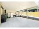 Ground-level covered parking with storage, exterior stairs, and a view of the fenced in yard at 5030 N Beach Rd # 1, Englewood, FL 34223