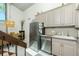 Modern kitchen with stainless steel appliances and granite countertops connected to dining area at 5030 N Beach Rd # 1, Englewood, FL 34223
