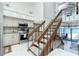 Modern kitchen with stainless steel appliances and an adjacent staircase with ocean views at 5030 N Beach Rd # 1, Englewood, FL 34223
