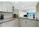 Kitchen with modern appliances, granite countertops, and a staircase with ocean views at 5030 N Beach Rd # 1, Englewood, FL 34223