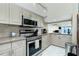 Modern kitchen with stainless steel appliances, granite countertops, and ample cabinet space at 5030 N Beach Rd # 1, Englewood, FL 34223
