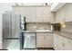 Bright kitchen with stainless steel appliances, granite countertops, and white cabinets at 5030 N Beach Rd # 1, Englewood, FL 34223