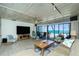 Open-concept living room with comfortable seating, tv, and ocean views at 5030 N Beach Rd # 1, Englewood, FL 34223