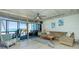 Bright living room with large sliding glass doors, comfortable seating, and ocean views at 5030 N Beach Rd # 1, Englewood, FL 34223