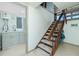 Interior staircase next to laundry area including modern sink, cabinets, and gray washing machine at 5030 N Beach Rd # 1, Englewood, FL 34223