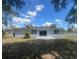 Home's back exterior featuring a sliding glass door and a newly installed patio at 5417 Postma St, North Port, FL 34287