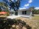 Home's back exterior featuring a sliding glass door and a newly installed patio at 5417 Postma St, North Port, FL 34287
