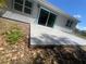 A grey patio off of the back of the house near a sliding glass door at 5417 Postma St, North Port, FL 34287
