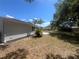 Backyard with a newly installed patio and tropical landscaping at 5417 Postma St, North Port, FL 34287