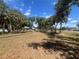 Scenic view of a community park with mature trees and playground equipment at 5417 Postma St, North Port, FL 34287