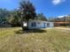Well kept one-story home featuring new front door, nicely landscaped yard with a palm tree, and a one-car garage at 5417 Postma St, North Port, FL 34287