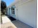 Close up of the house featuring a one car garage and new turquoise window trim at 5417 Postma St, North Port, FL 34287