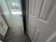 Neutral hallway with wood-look tile floor with white door and trim at 5417 Postma St, North Port, FL 34287