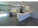 Beautifully renovated kitchen featuring modern appliances, white cabinets, new tile backsplash, and an island with bar seating at 5417 Postma St, North Port, FL 34287