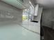 Quartz countertops accent white cabinets and new stainless steel sink under a bright window at 5417 Postma St, North Port, FL 34287