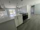Newly remodeled kitchen boasts a marble island and stainless steel appliances at 5417 Postma St, North Port, FL 34287