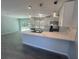 Open kitchen with stainless steel appliances, marble countertops, and island at 5417 Postma St, North Port, FL 34287