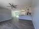 Open floor plan with tile flooring and an updated kitchen featuring white cabinets and stainless steel appliances at 5417 Postma St, North Port, FL 34287
