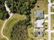 An aerial view of homes situated adjacent to a golf course, each featuring private pools and well-manicured lawns at 56 Long Meadow Ct, Rotonda West, FL 33947