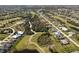 Aerial shot of homes near a golf course and lakes, showing the layout and community amenities at 56 Long Meadow Ct, Rotonda West, FL 33947