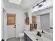Bathroom with modern vanity, decorative plant, and a large mirror to brighten the space at 56 Long Meadow Ct, Rotonda West, FL 33947