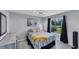 A cozy bedroom featuring stylish decor, a large window, and a calming color scheme at 56 Long Meadow Ct, Rotonda West, FL 33947
