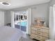 Bright bedroom featuring a view of the pool, neutral decor, and a ceiling fan for a cozy feel at 56 Long Meadow Ct, Rotonda West, FL 33947