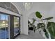 Bright entryway featuring an arched doorway, large plant, and tiled flooring at 56 Long Meadow Ct, Rotonda West, FL 33947