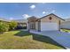 Well-maintained single-story house with a manicured lawn and a paved driveway at 56 Long Meadow Ct, Rotonda West, FL 33947