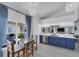Eat-in kitchen with blue cabinets, granite countertops, and a stainless steel dishwasher at 56 Long Meadow Ct, Rotonda West, FL 33947