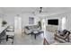 Open-concept living room with tile floors, modern furniture, and a view into the kitchen at 56 Long Meadow Ct, Rotonda West, FL 33947