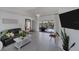 Bright living room with tiled floors, stylish decor, and a view of the outdoor pool at 56 Long Meadow Ct, Rotonda West, FL 33947
