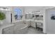 This spacious main bathroom boasts a tub, vanity, and a large mirror providing ample natural light at 56 Long Meadow Ct, Rotonda West, FL 33947