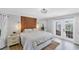 Bright main bedroom with a decorative headboard and access to the patio at 56 Long Meadow Ct, Rotonda West, FL 33947