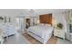 Light and bright main bedroom with wood accent wall, side tables and attached bathroom at 56 Long Meadow Ct, Rotonda West, FL 33947