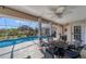 Covered lanai with a view of the pool, outdoor seating and garden views, ideal for relaxation at 56 Long Meadow Ct, Rotonda West, FL 33947